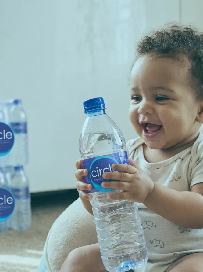 Happy toddler drinking clear water